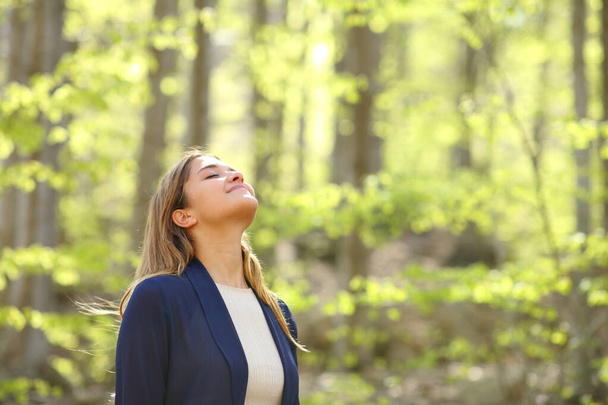 Relaxed casual woman breaths fresh air in a green forest - Zdjęcie, obraz