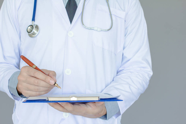 Lékař v bílé uniformě se stetoskopem držení pera psaní hlášení nemoc pacientky s rakovinou prsu, Lékařská, Zdravá koncepce - Fotografie, Obrázek