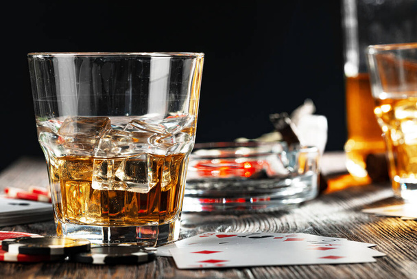 Playing poker with whiskey and cigars on table - Foto, Imagen