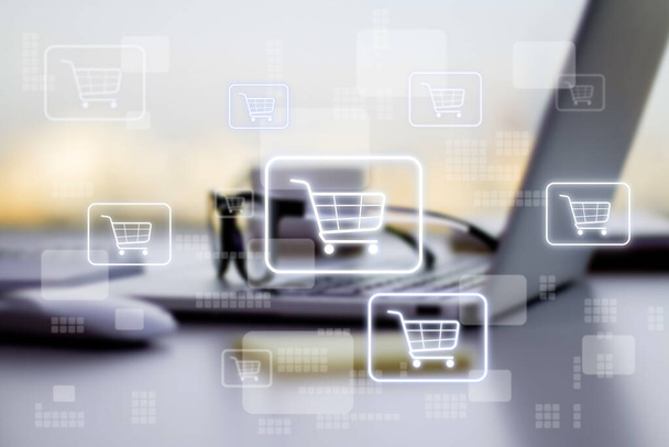 Online shopping concept with digital supermarket cart in squares on blurry laptop background - Photo, image