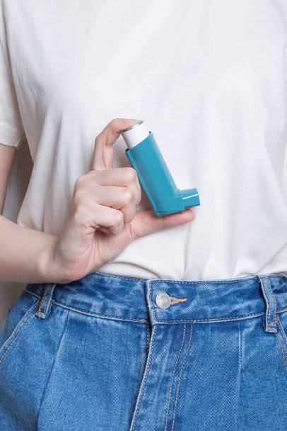Woman holds inhaler to treat asthma. World Asthma Day. Concept of allergy care - Fotó, kép