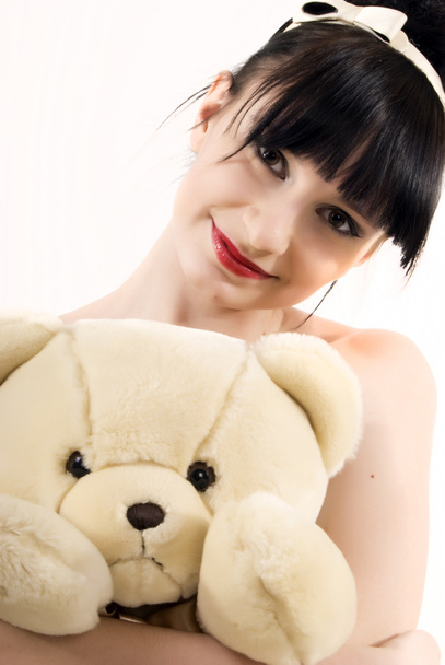 Young brunette with teddy bear isolated on white - Foto, immagini