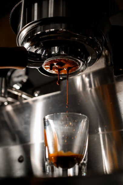 making espresso on coffee machine through portafilter from arabica coffee - Valokuva, kuva