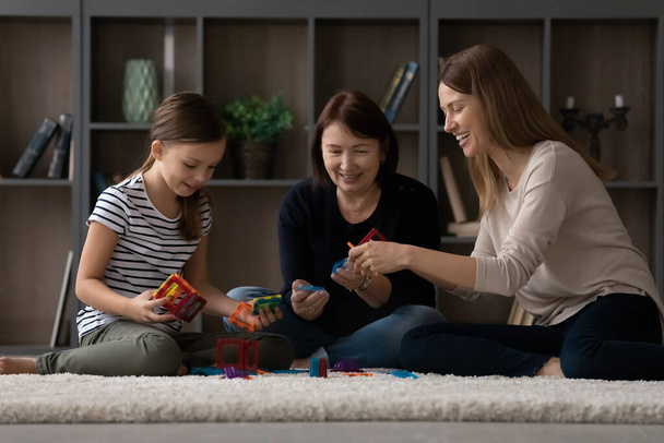 Happy three generations of women play at home - Foto, Bild