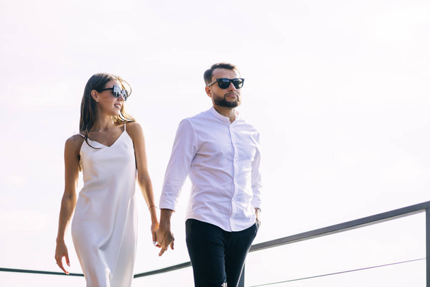 Happy young fashionable couple in love walks outdoors after wedding ceremony. - Foto, immagini