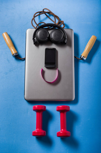 A positive person from objects. A man made of sports and electronic items. Vertical frame. - Photo, Image