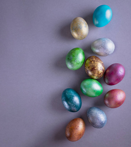 Colorful Easter eggs. Easter background. Minimalistic Easter concept on gray background. Card with copy space for text. - Photo, Image