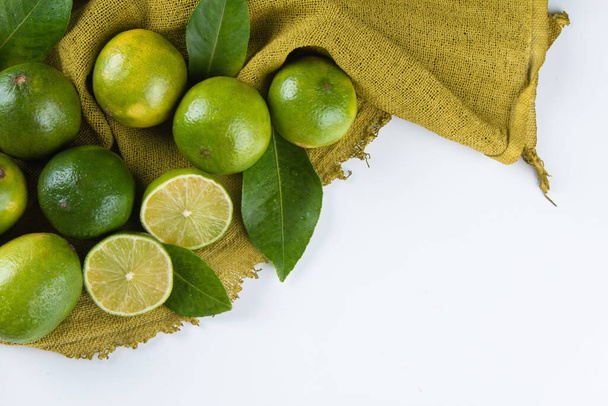 Ripe green lemon fruit on white background. - Foto, afbeelding