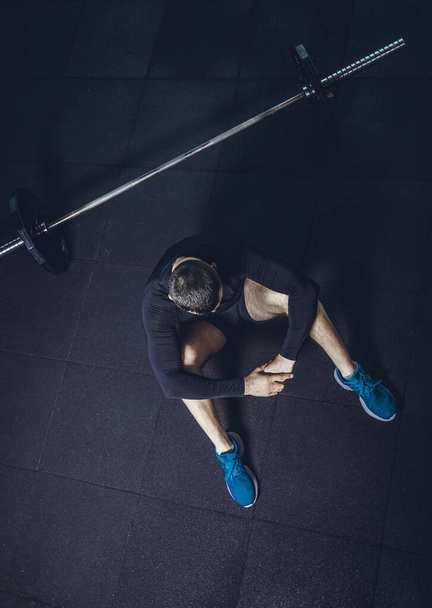 High resulotion image. Bearded handsome young fitness man sitting relaxed at the gym after workout smiling joyfully copyspace motivation confidence sports lifestyle happiness active people concept. - 写真・画像