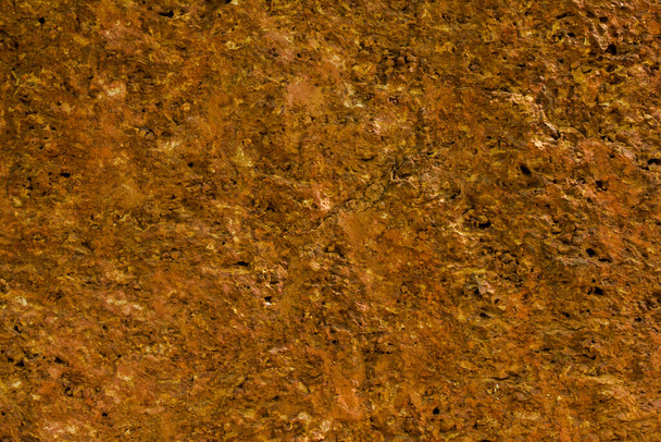 yellow amber smooth stone wall. rough natural texture surface - Photo, Image