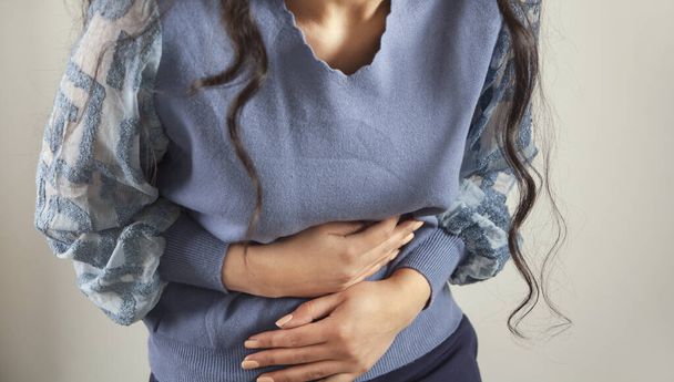 young sad woman hand in ache stomache - Foto, immagini