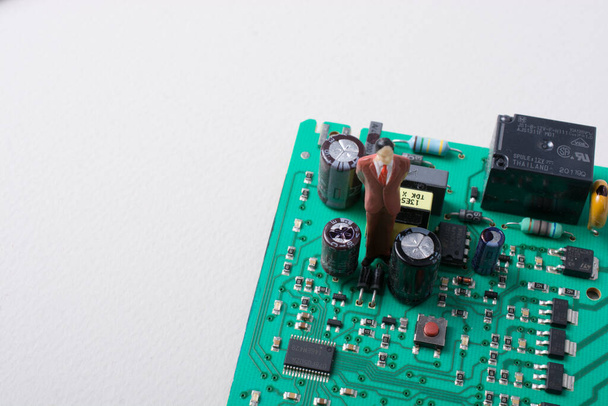 Figura pequeña de los hombres modelo en la placa de circuito de la electrónica
 - Foto, imagen