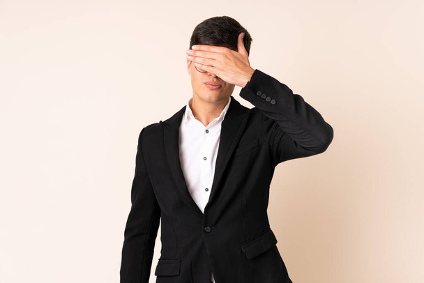 Businessman over isolated beige background covering eyes by hands - Photo, Image