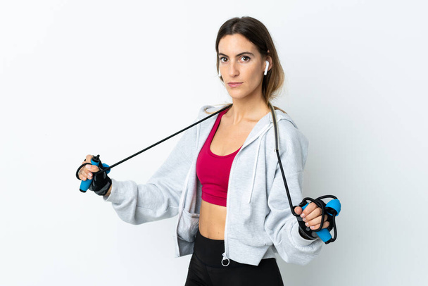 Young sport woman over isolated background with jumping rope - Photo, image