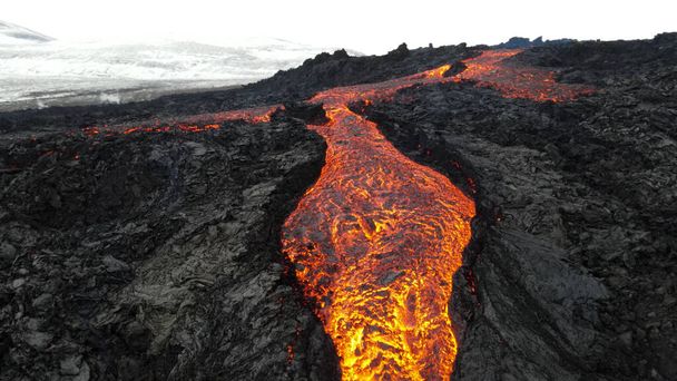 erupción de lava volcán con montañas nevadas, vista aérea lava caliente y magma saliendo del cráter, abril 2021  - Foto, imagen