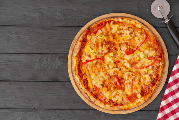 Tasty pizza on black wooden background top view - Foto, Imagen