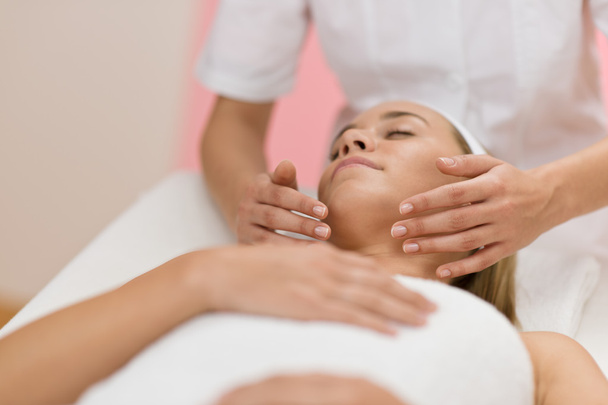 Body care - Woman receive luxury facial massage at day spa - Photo, Image