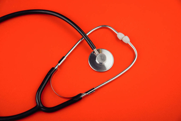 Medical stethoscope isolated on red background - Foto, Imagen