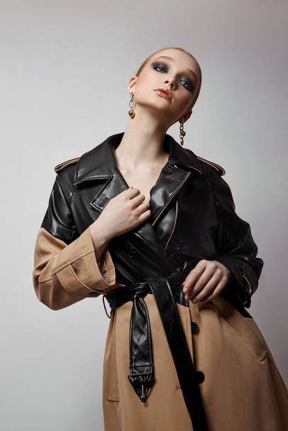 Beauty fashion young woman in trench coat, professional face makeup girl. Portrait of woman on white background. Spring clothing in rainy weather - Valokuva, kuva