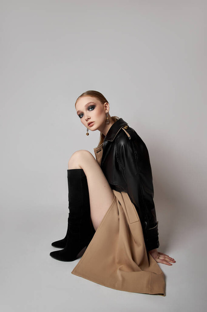 Beauty fashion young woman in trench coat, professional face makeup girl. Portrait of woman on white background. Spring clothing in rainy weather - Φωτογραφία, εικόνα