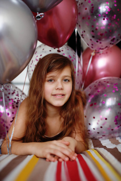 birthday pretty  girl is laying on the bed with balloons - Valokuva, kuva