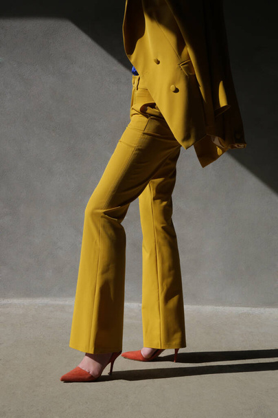 Fashionable young woman in yellow tailored suit. - Fotografie, Obrázek
