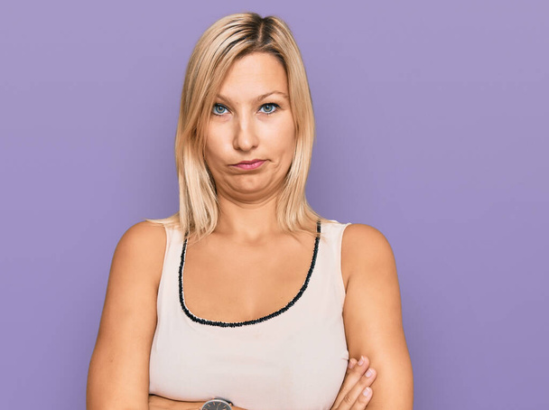 Middle age caucasian woman wearing casual clothes skeptic and nervous, disapproving expression on face with crossed arms. negative person.  - Photo, Image