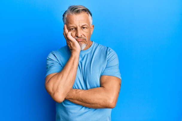 Middle age grey-haired man wearing casual clothes thinking looking tired and bored with depression problems with crossed arms.  - Fotografie, Obrázek