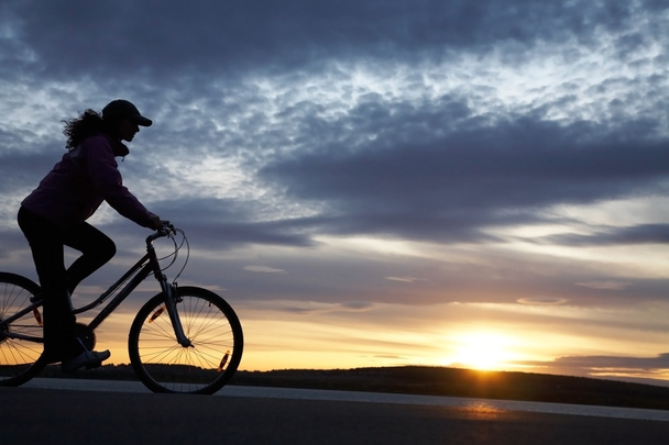 Silhouette einer Radfahrerin - Foto, Bild