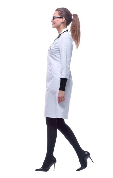 side view. smiling female medic striding confidently forward. - Fotografie, Obrázek