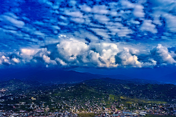 beautiful cumulus clouds over the city - Фото, изображение