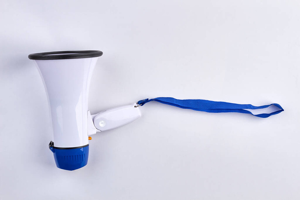 Bullhorn with blue ribbon. Isolated on white background. - Foto, imagen