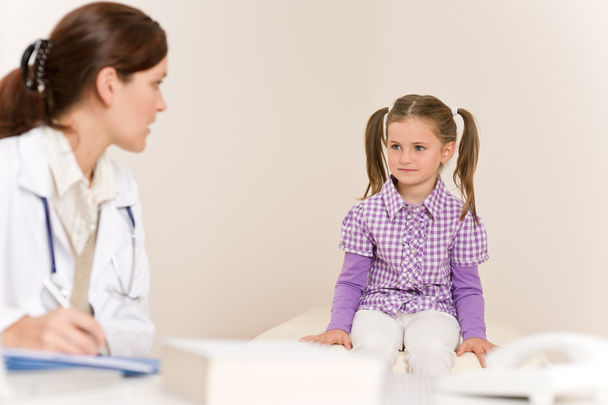 Female doctor write prescription for child at clinic - Foto, Imagem