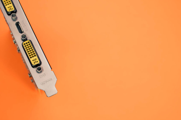 A top view of a computer graphics card on an orange background - Fotó, kép