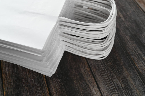 Stack of paper white package on wooden background  - Foto, Imagen