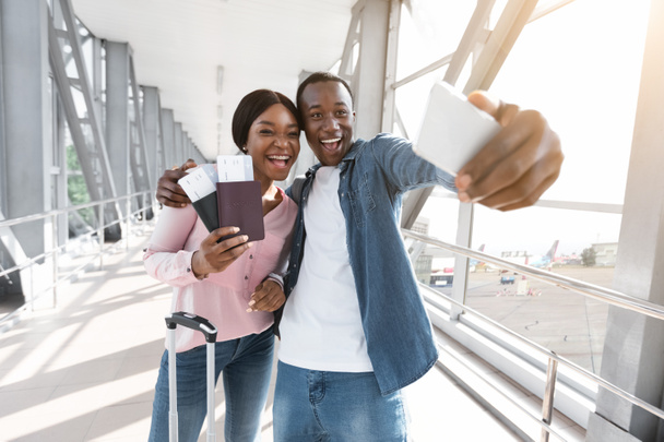 Prêt pour les aventures. Joyeux couple noir prenant Selfie avec Smartphone à l'aéroport - Photo, image
