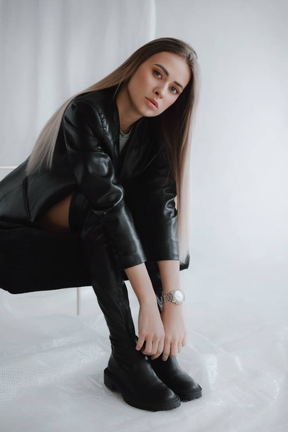 Girl in a stylish bodysuit and a leather jacket. Natural colors. Trend of 2021. Natural female beauty. - 写真・画像