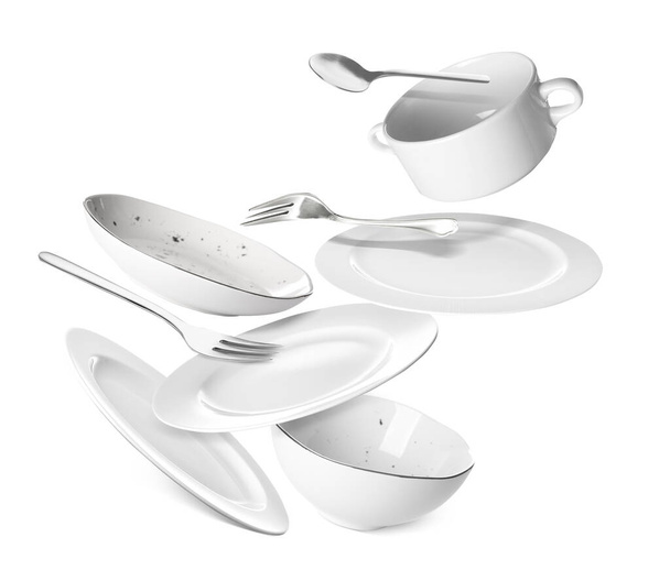 Flying clean tableware on white background - Foto, Imagen