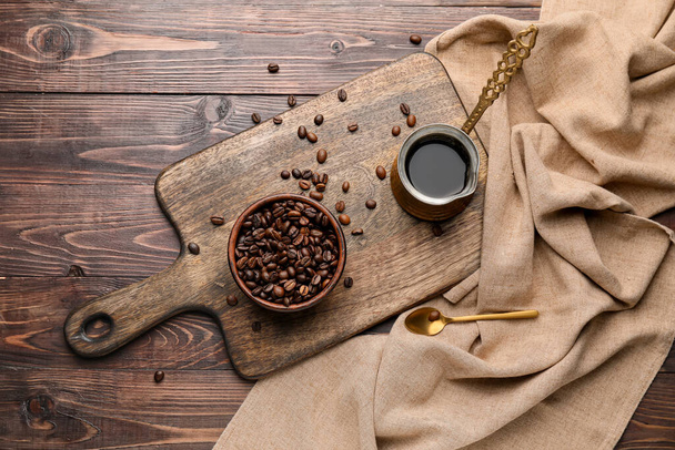 Kaffeekanne und Schüssel mit Bohnen auf Holzgrund - Foto, Bild
