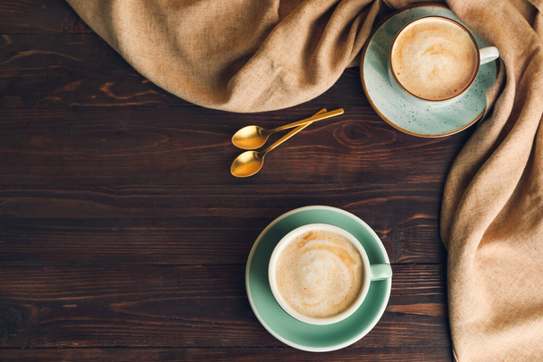 Cups of hot cappuccino on wooden background - Φωτογραφία, εικόνα