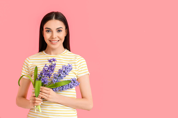 Beautiful young woman with hyacinth flowers on color background - Fotografie, Obrázek