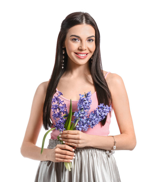 Beautiful young woman with hyacinth flowers on white background - Φωτογραφία, εικόνα