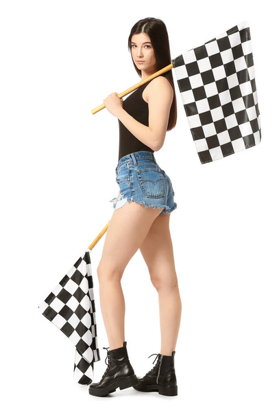 Beautiful young woman with racing flags on white background - Photo, Image