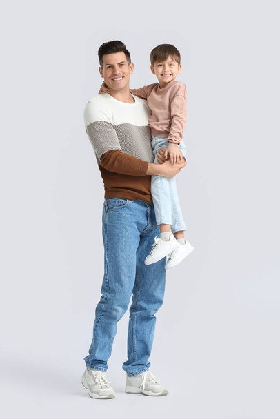 Happy father and his little son on light background - Foto, Imagem