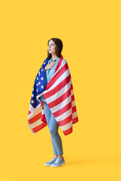 Sad young woman with USA flag on color background. Memorial Day celebration - Foto, Imagem