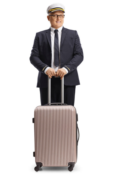 Pilot standing with a suitcase isolated on white background - Fotó, kép