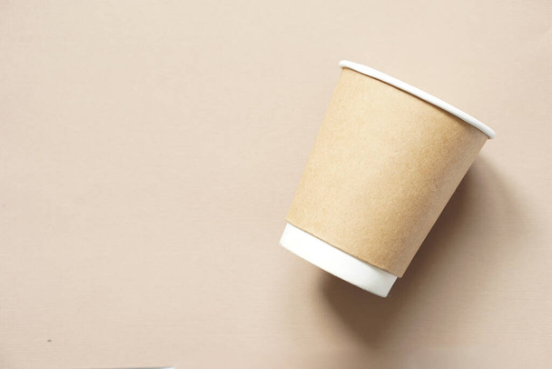 top view of a brown paper cup placed on brown paper. - Photo, image