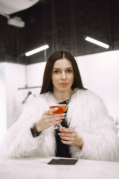 Girl drinking a red cocktail in a cafe - Zdjęcie, obraz