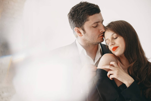 Portrait of young couple in love posing at studio - Фото, зображення