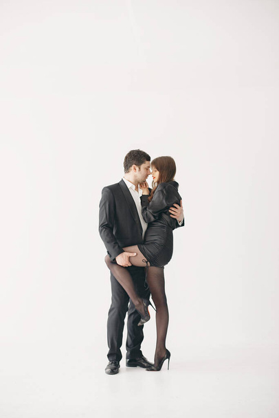 Portrait of young couple in love posing at studio - Foto, Imagem